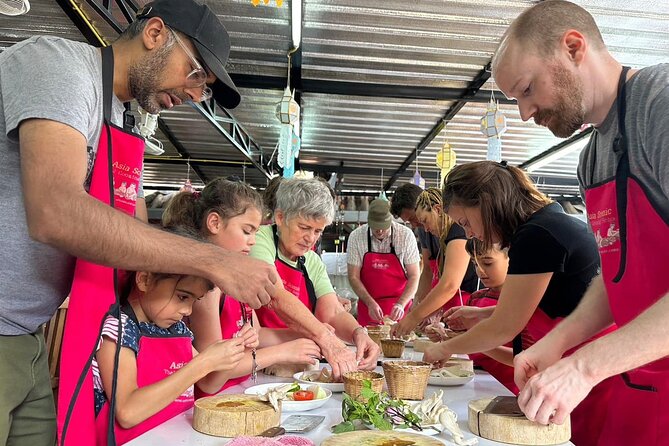 Authentic Thai Cooking Class and Farm Visit in Chiang Mai - Cooking in an open-air kitchen