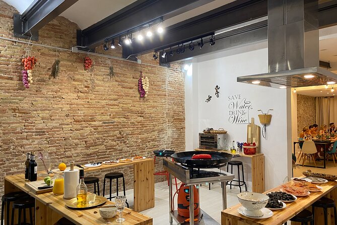 Barcelona: Black Ink Seafood Paella Cooking Class - Sharing the work at the stove