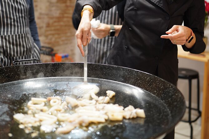 Barcelona: Black Ink Seafood Paella Cooking Class - Sitting down to the black seafood paella
