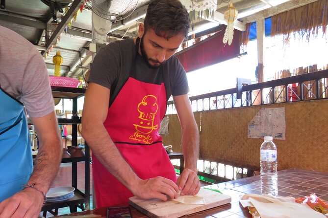 Half-Day Thai Cooking Class and Market Tour From Chiang Mai - From Tha Phae Gate to the open-air kitchen