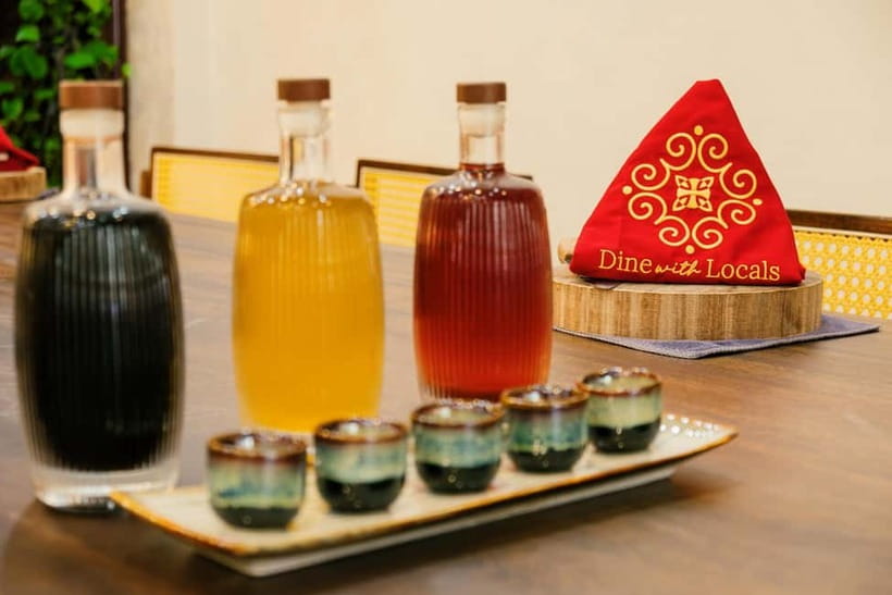 Hanoi Cooking Class: Market Tour, Free Recipe & Beverages - Homemade wine and drinks at the table