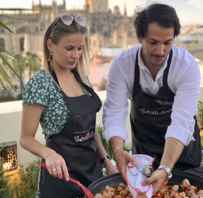 Seville: Paella Cooking Class & 30-Min Local Expert Q&A - Mixing sangria and sharing the finished meal